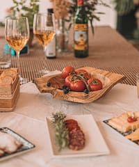 a table with food and wine glasses