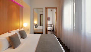 a bedroom with a bed and a mirror