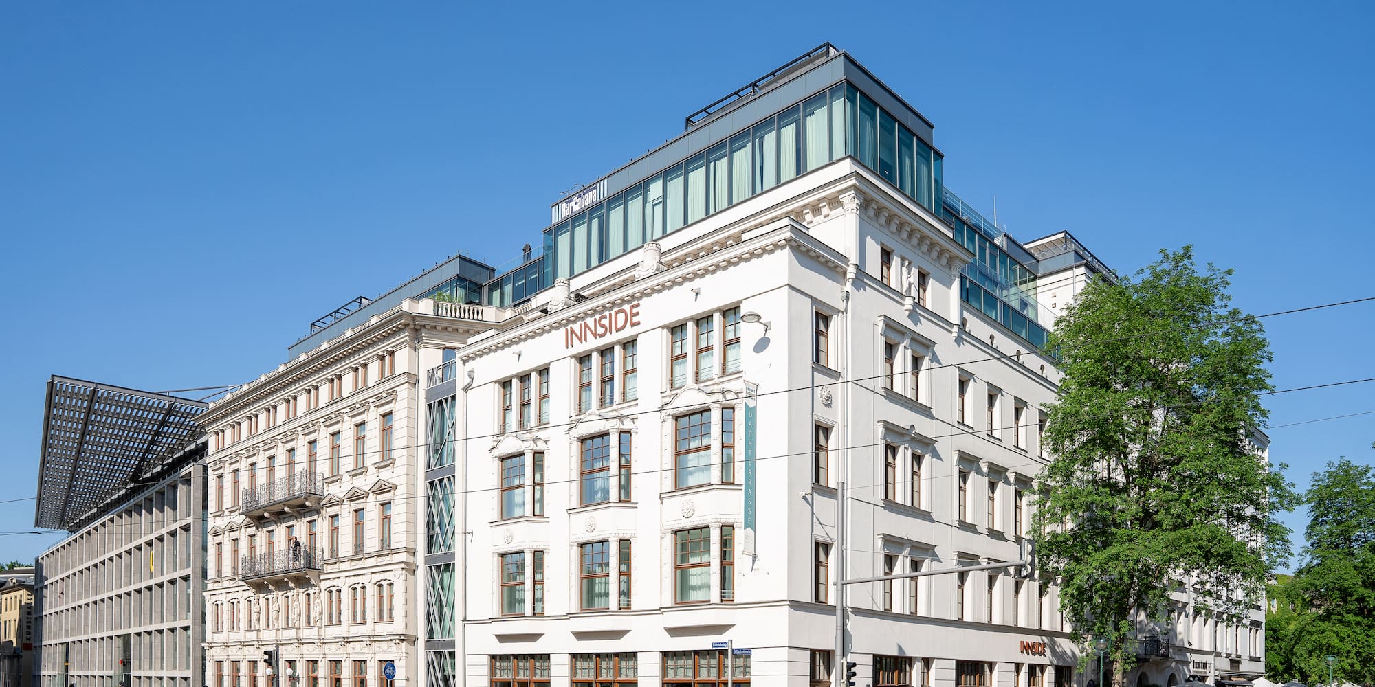 a white building with windows and a street corner