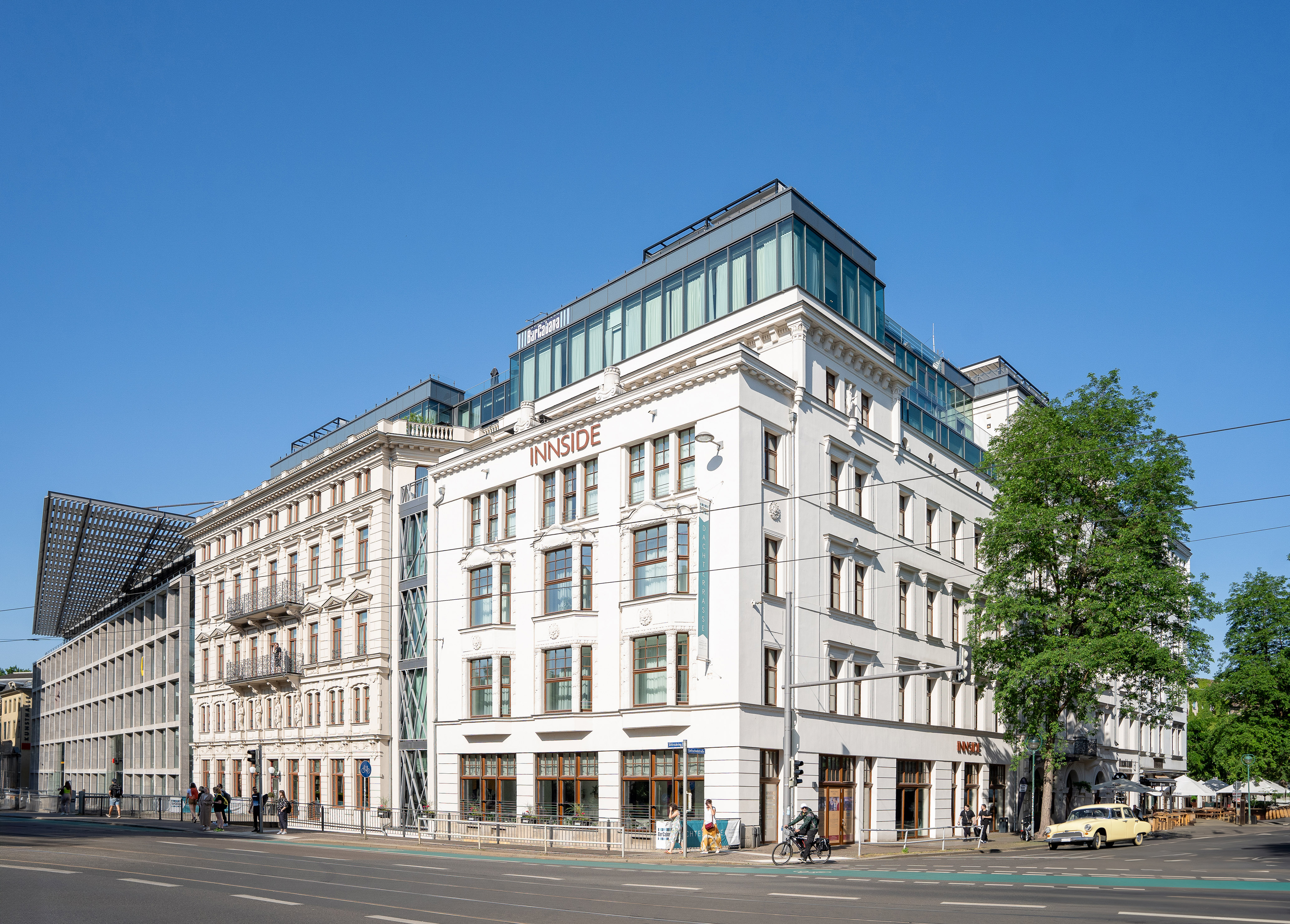 a white building with windows and a street corner