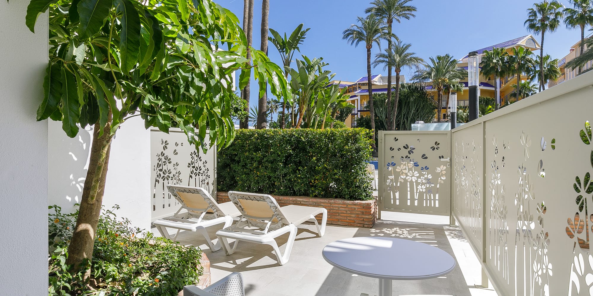 a patio with chairs and tables