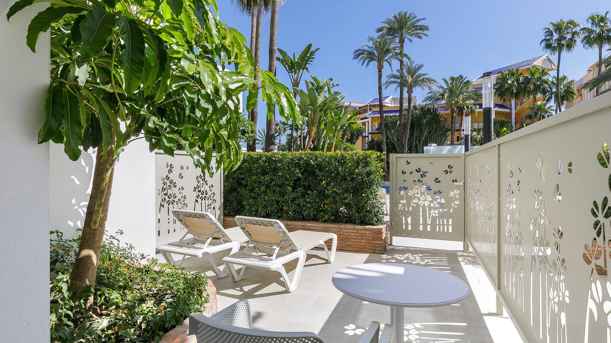 a patio with chairs and tables