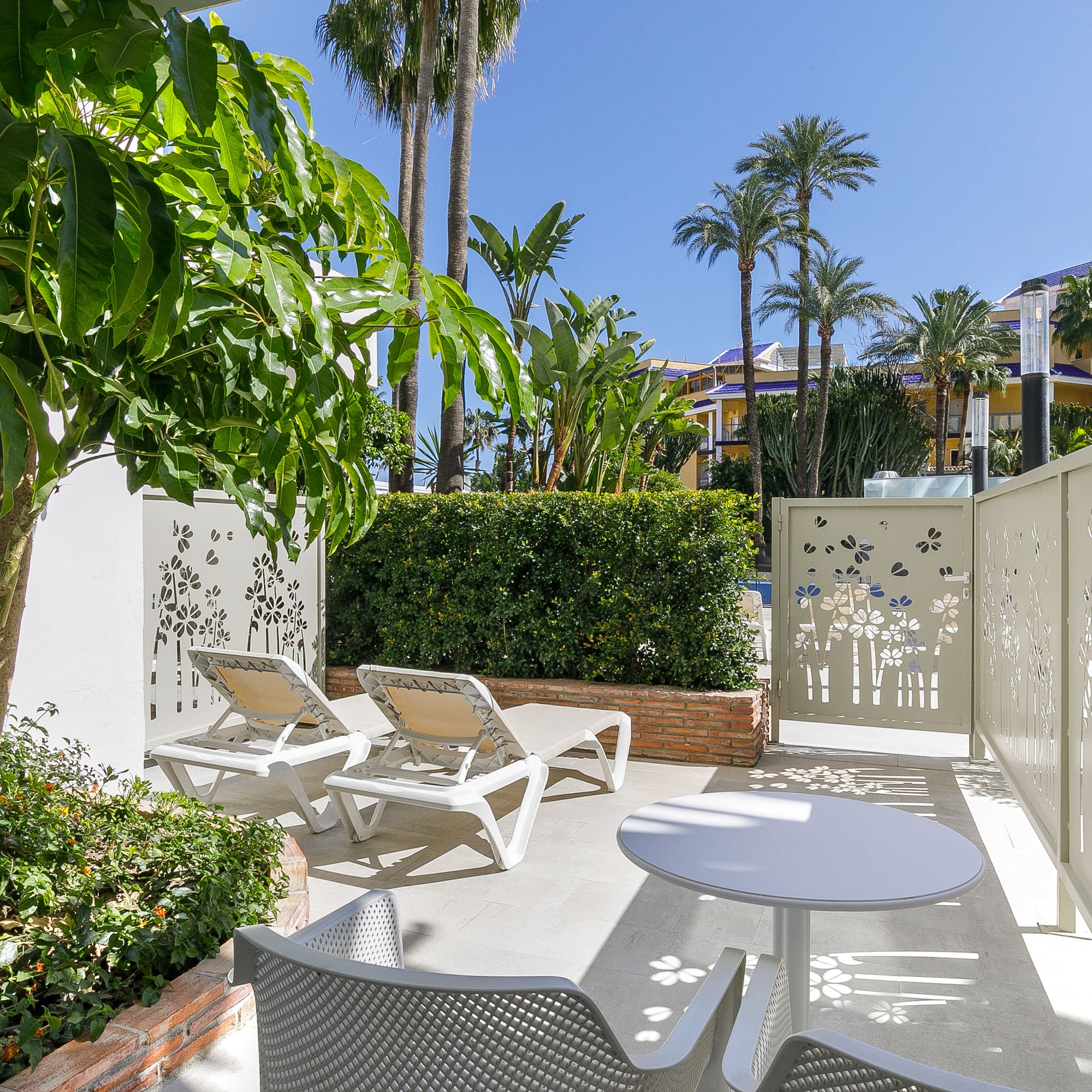 a patio with chairs and tables