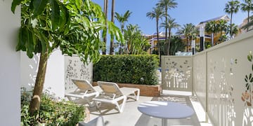 a patio with chairs and tables