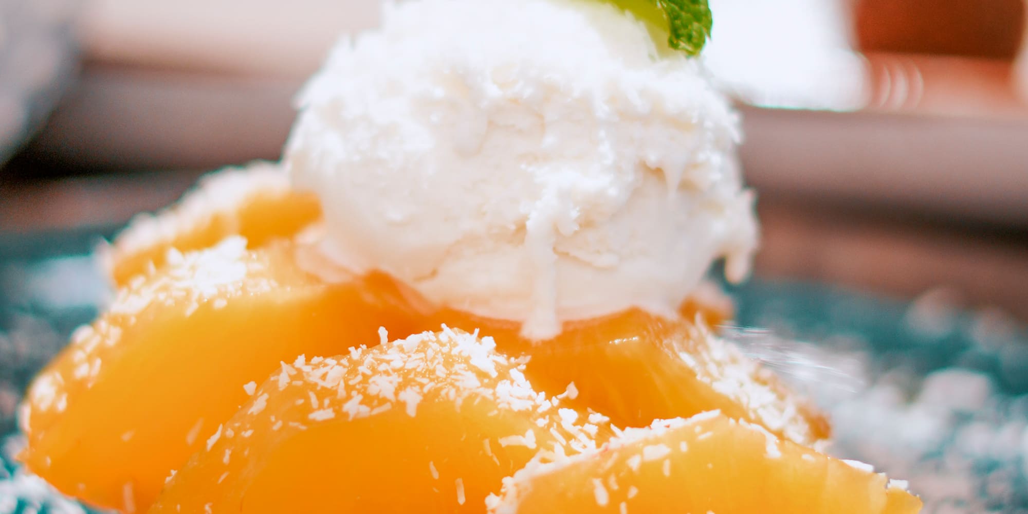 a plate of fruit with a scoop of ice cream on top