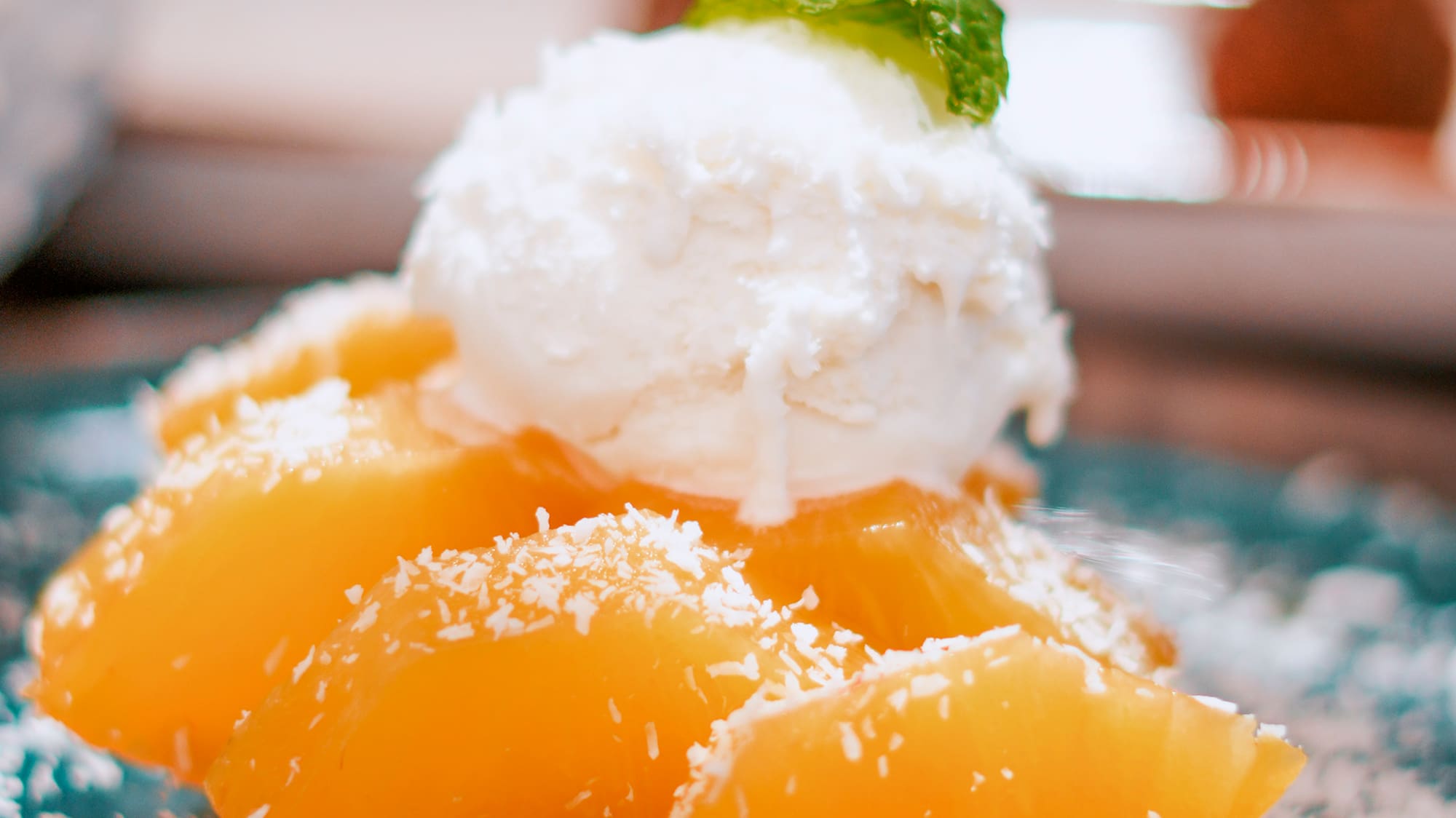 a plate of fruit with a scoop of ice cream on top
