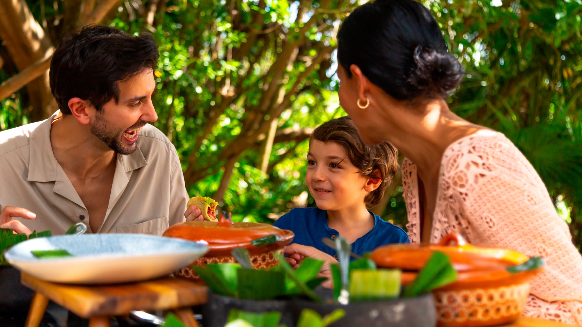 a group of people sitting at a table with food