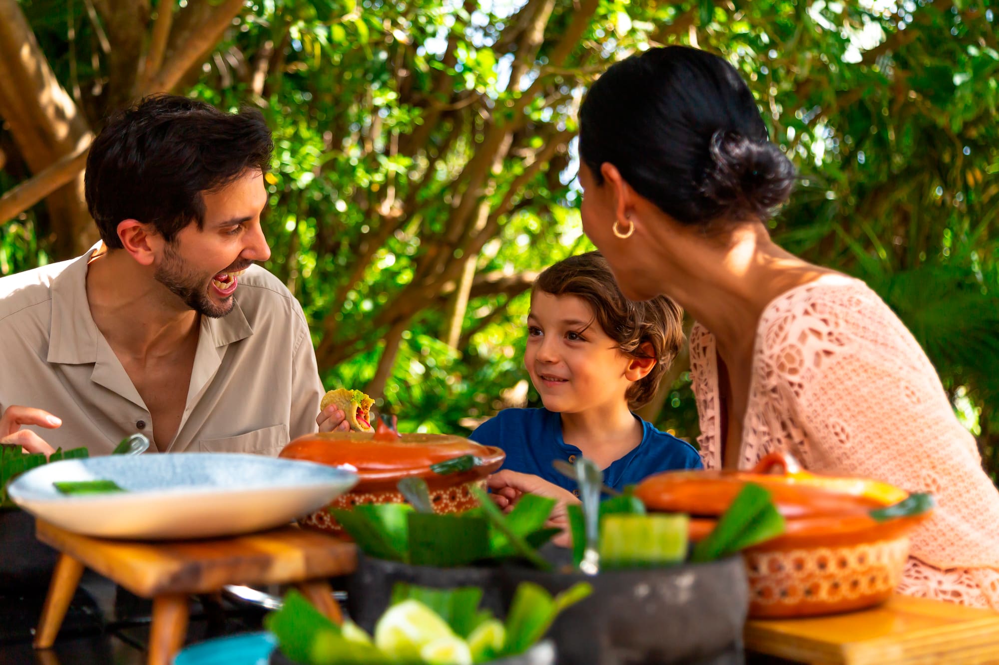 a group of people sitting at a table with food