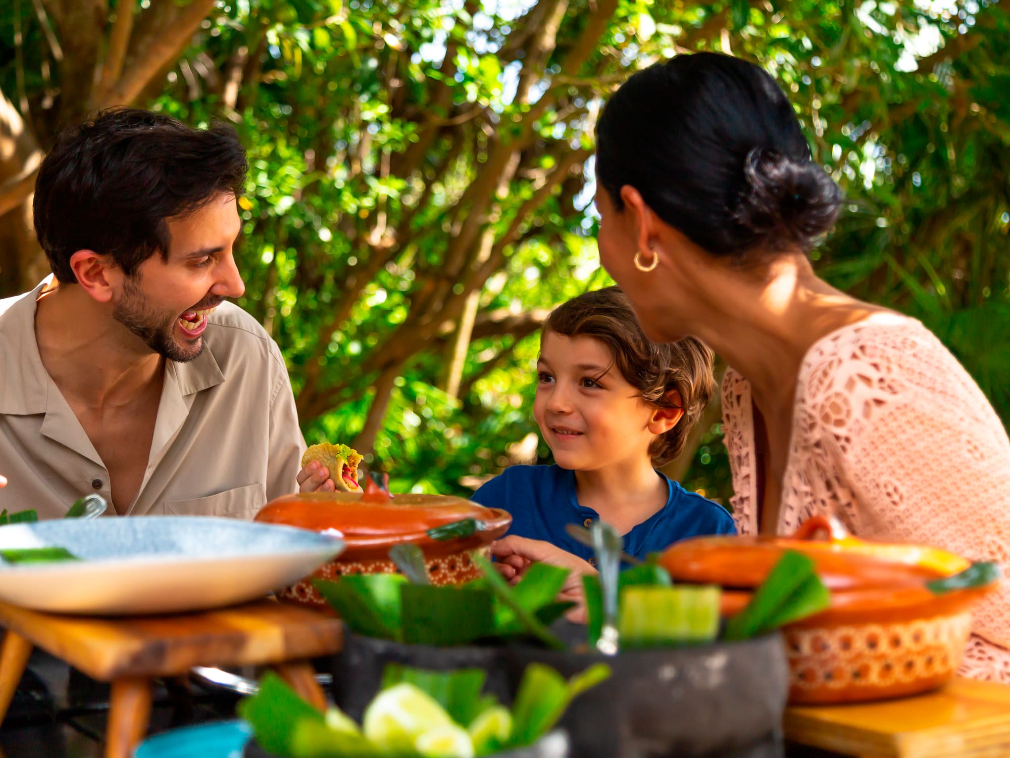 a group of people sitting at a table with food