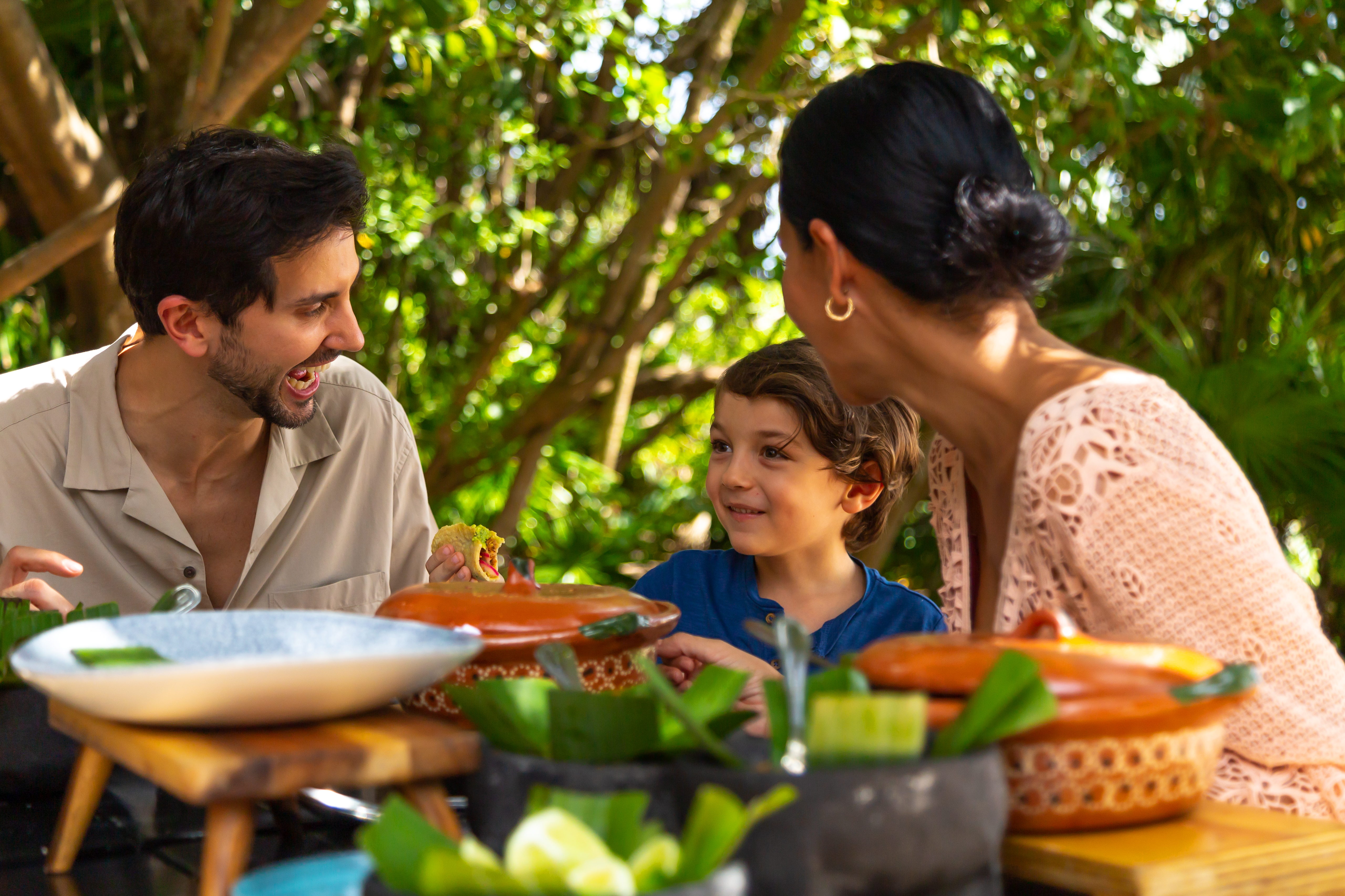 a group of people sitting at a table with food