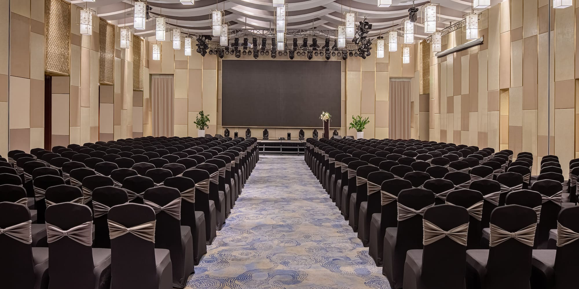 a room with chairs and a screen