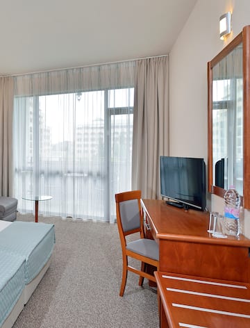 a room with a desk and a bed