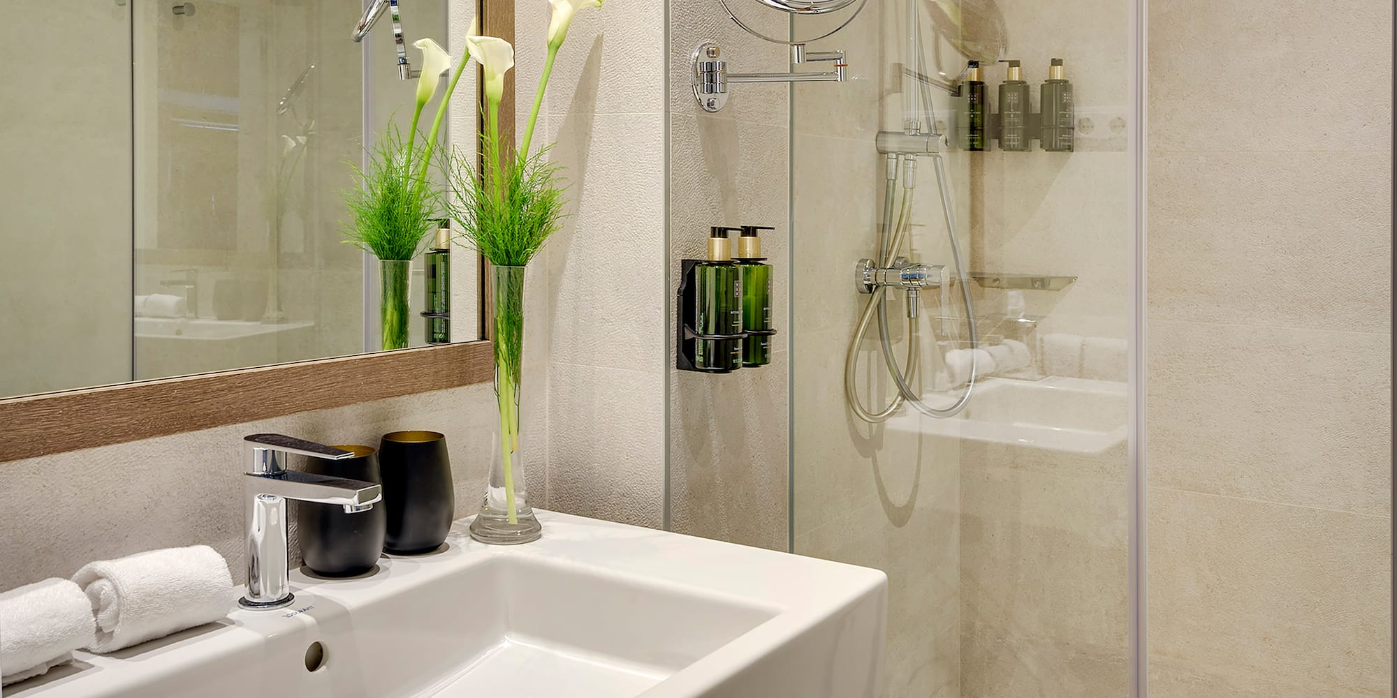 a bathroom with a glass shower and sink