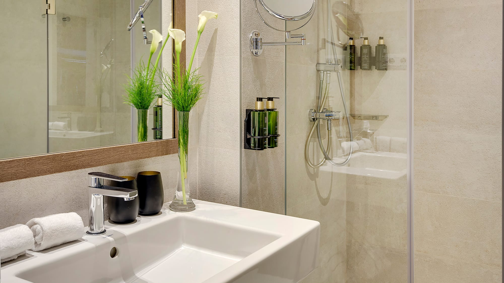 a bathroom with a glass shower and sink