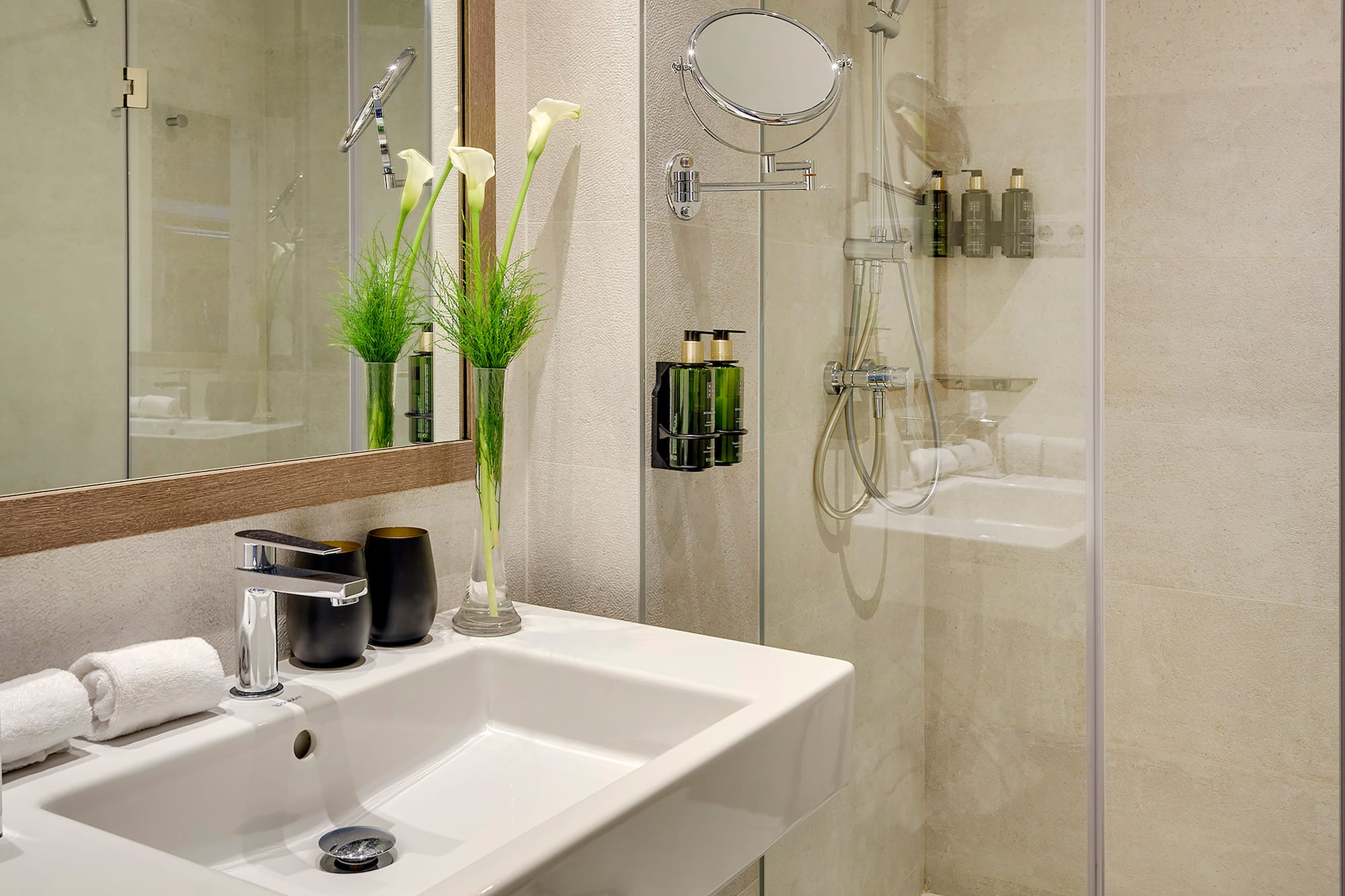 a bathroom with a glass shower and sink