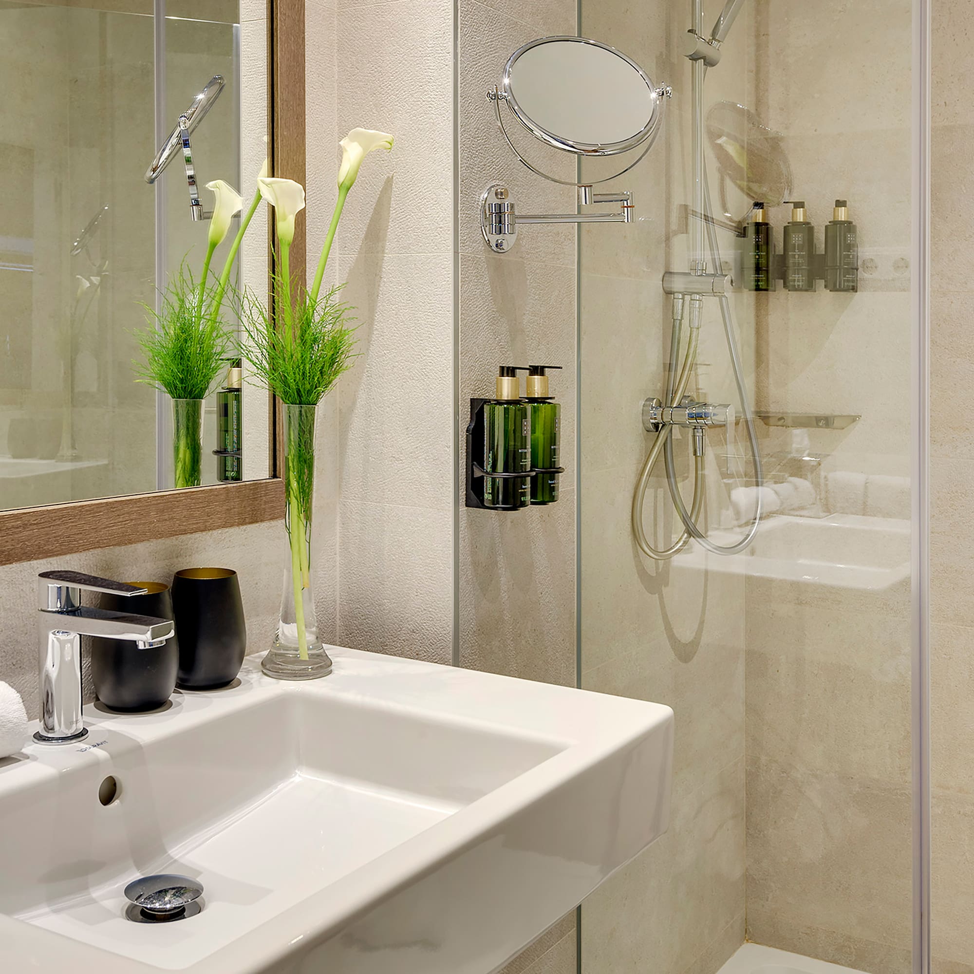 a bathroom with a glass shower and sink