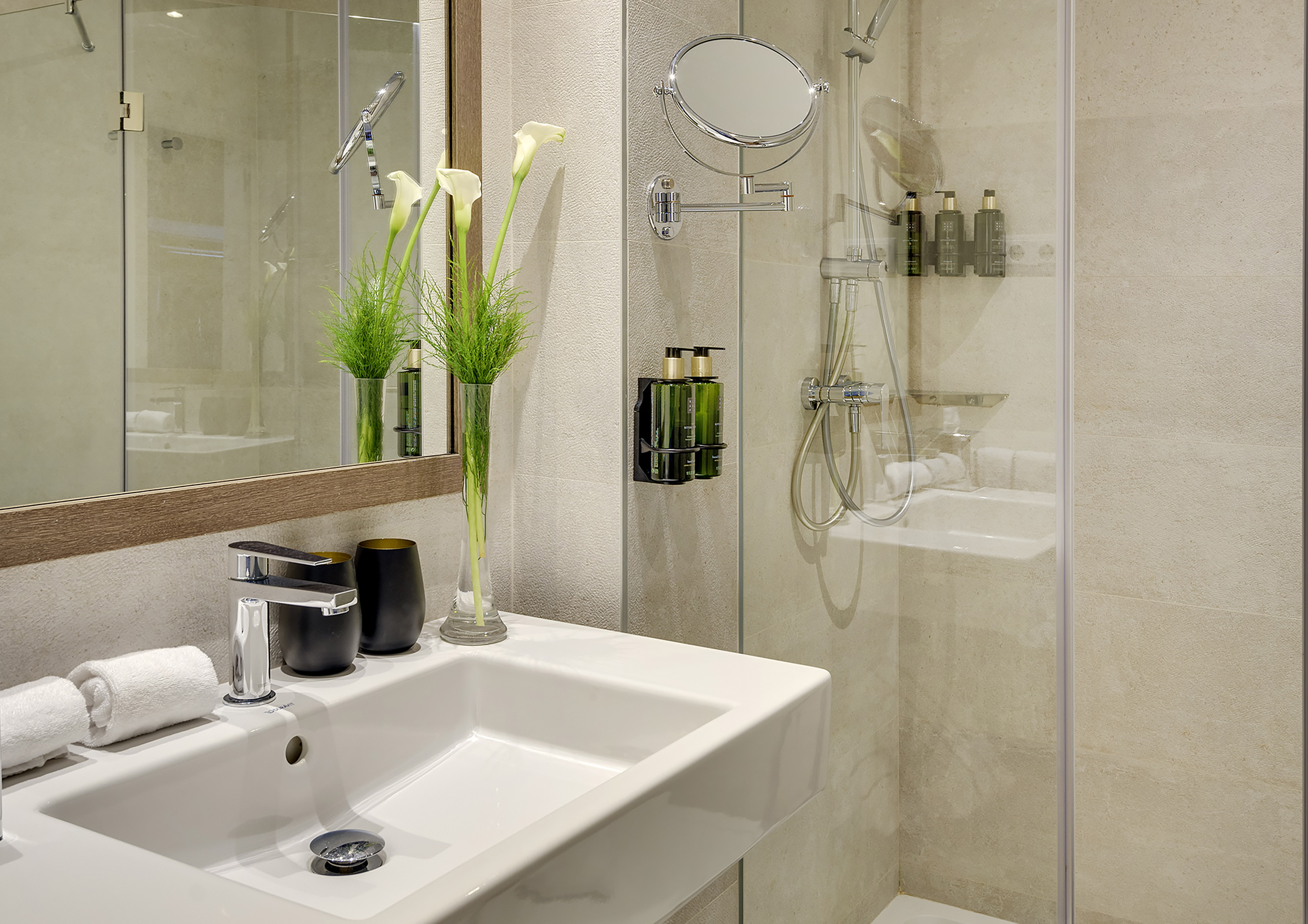 a bathroom with a glass shower and sink