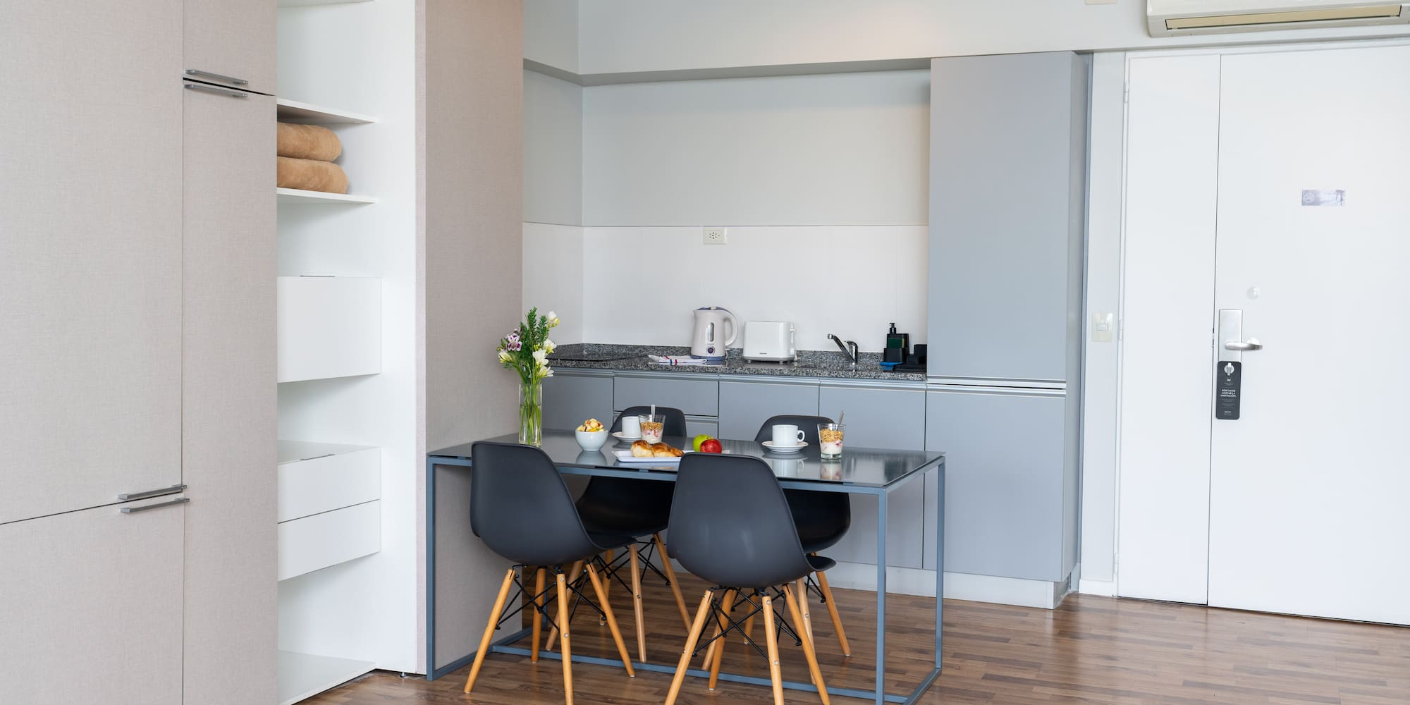 a kitchen with a table and chairs