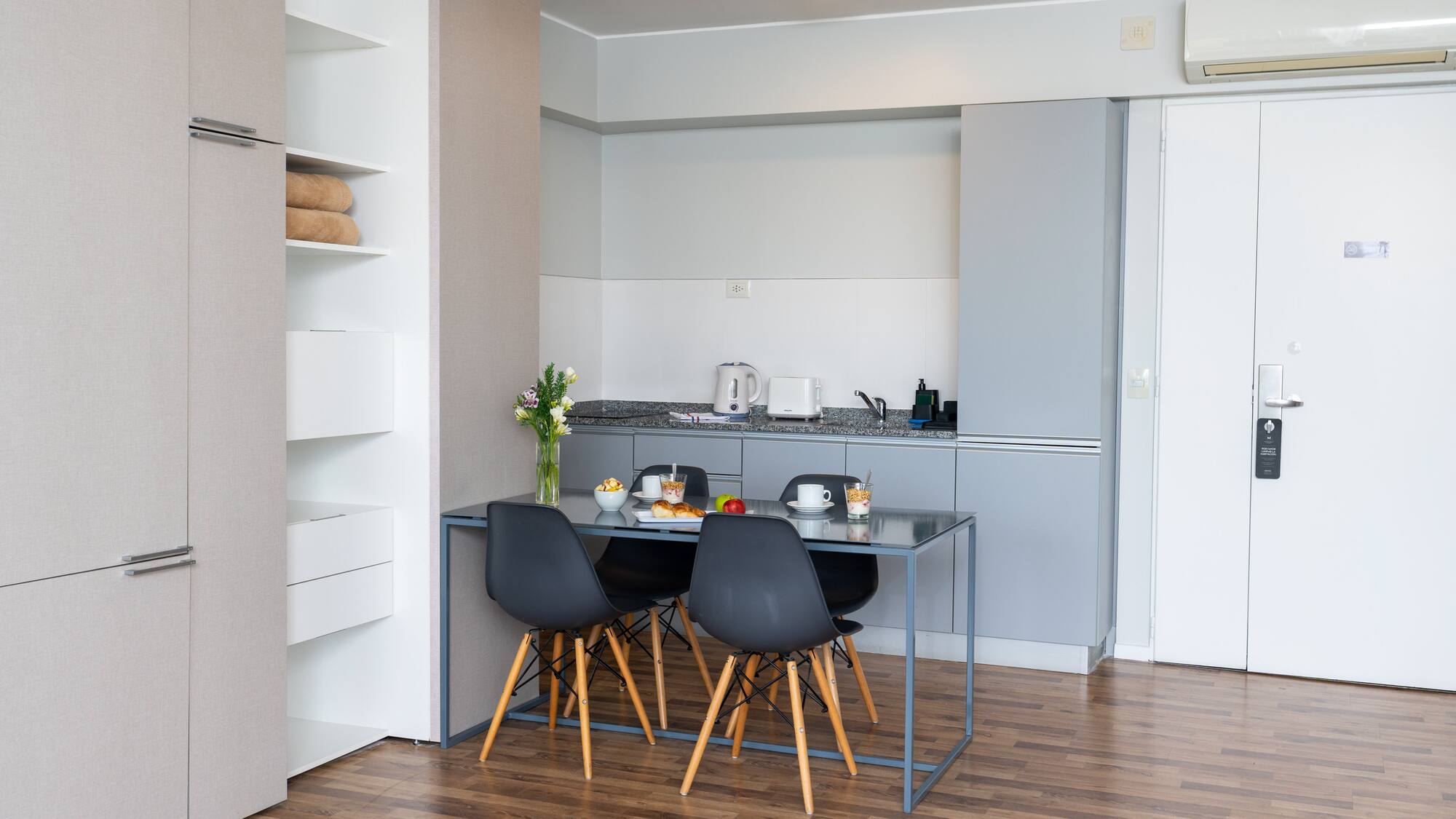a kitchen with a table and chairs