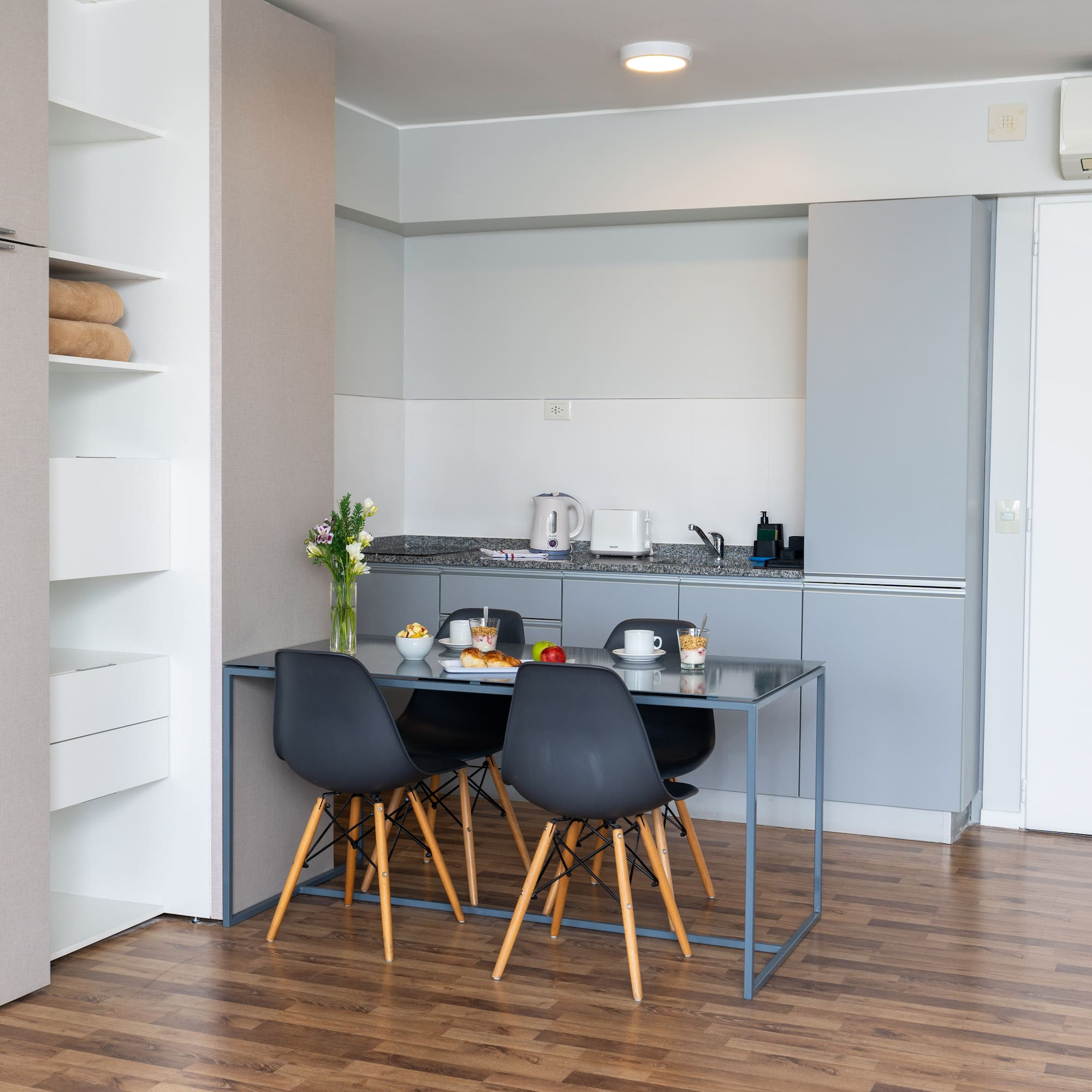 a kitchen with a table and chairs