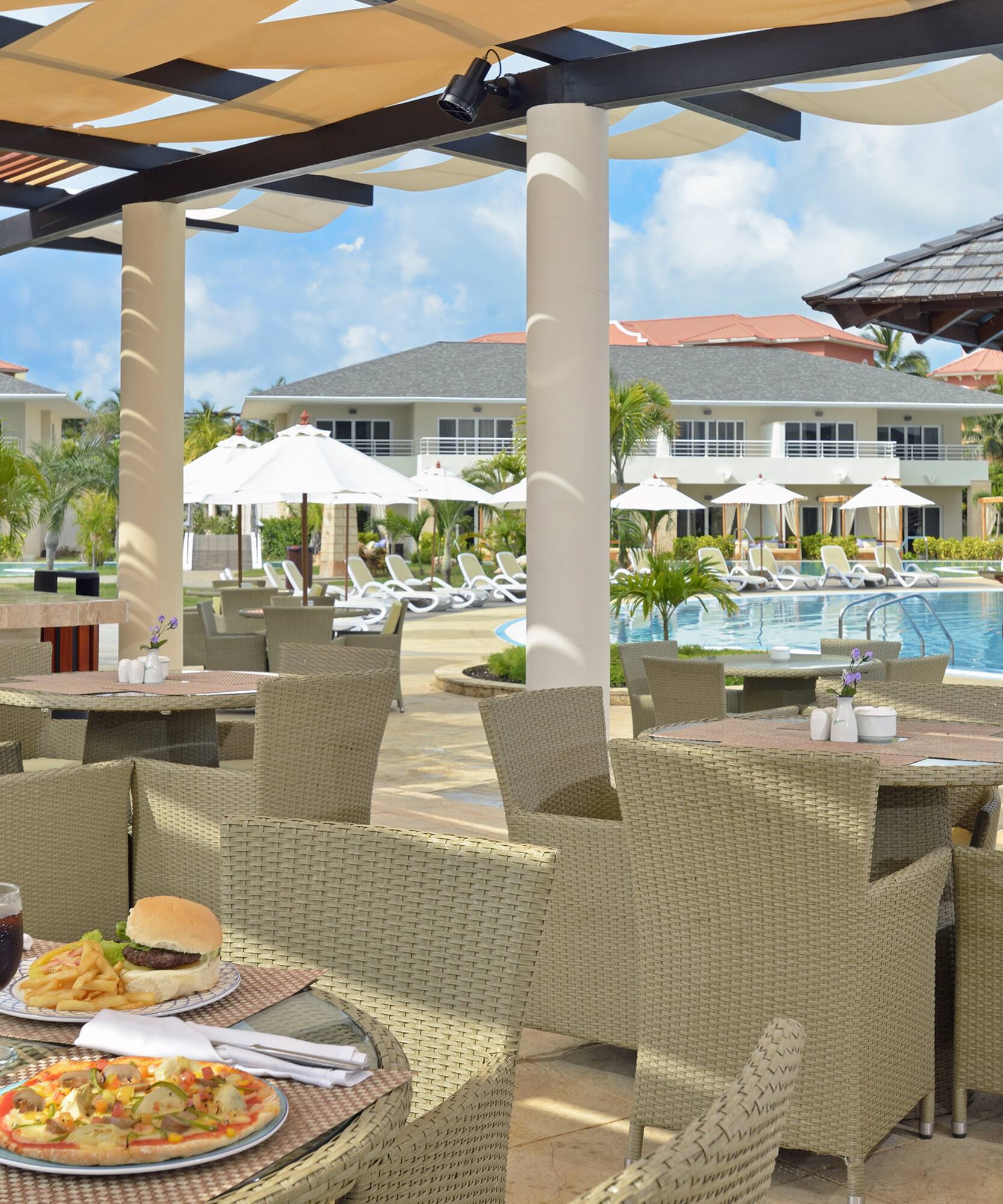 a restaurant with tables and chairs and a pool