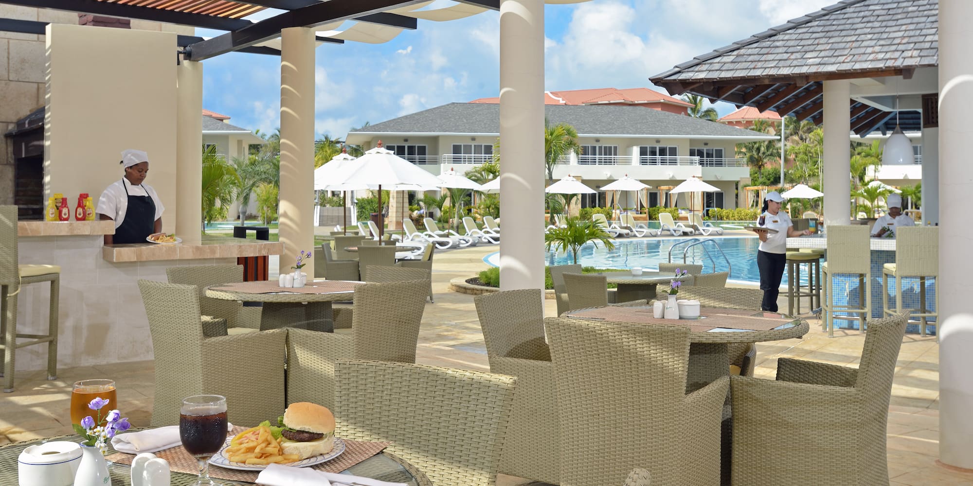 a restaurant with tables and chairs and a pool