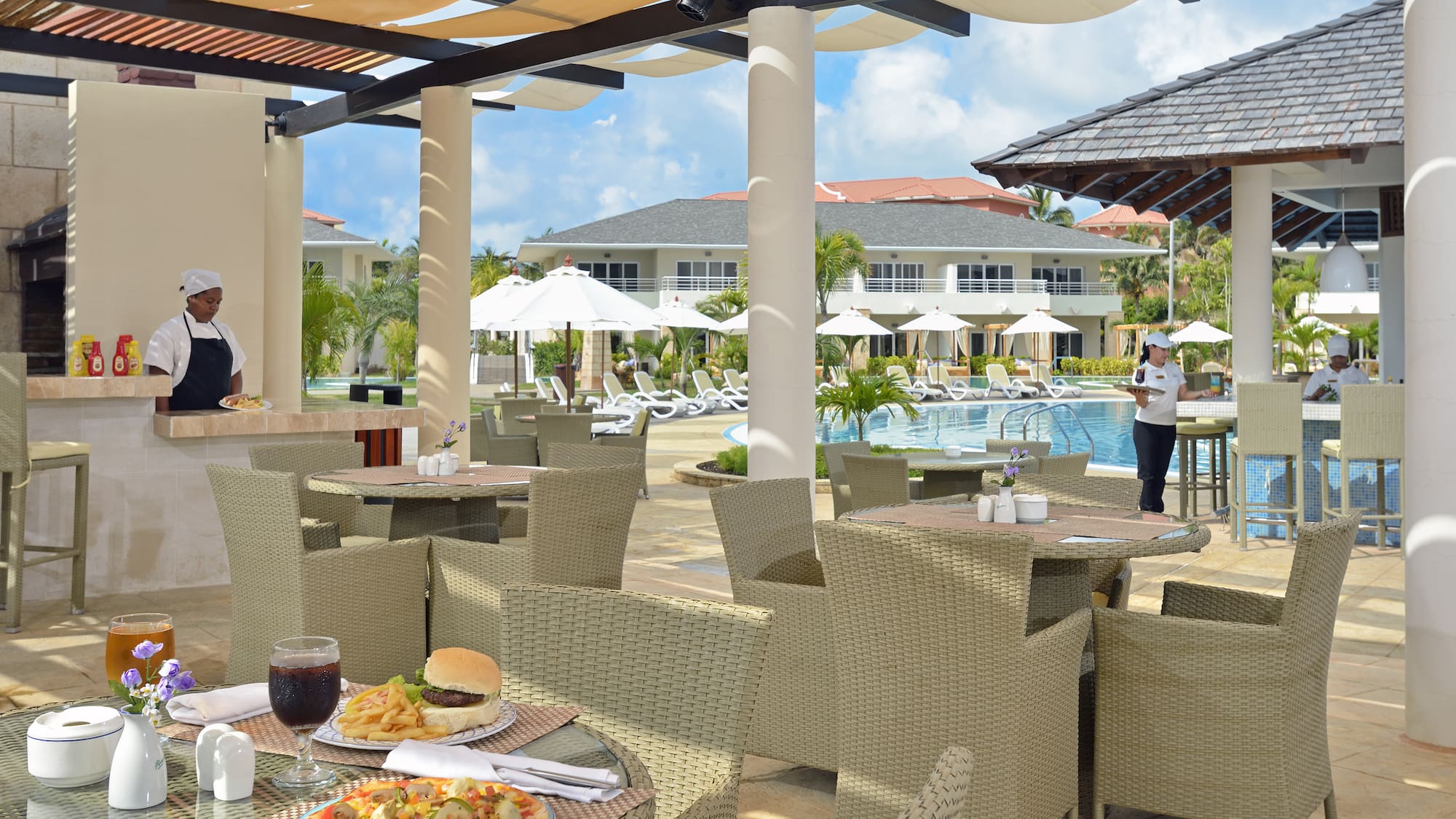 a restaurant with tables and chairs and a pool