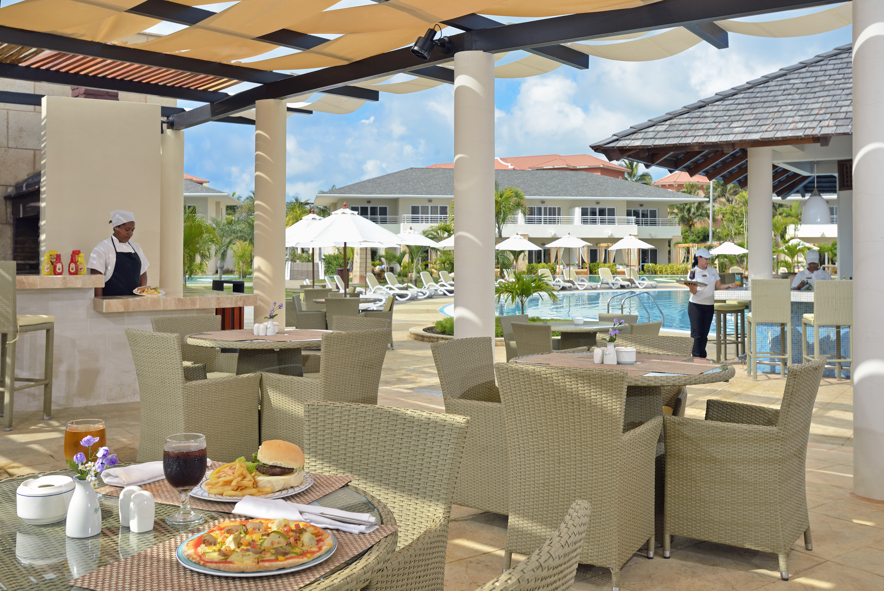 a restaurant with tables and chairs and a pool