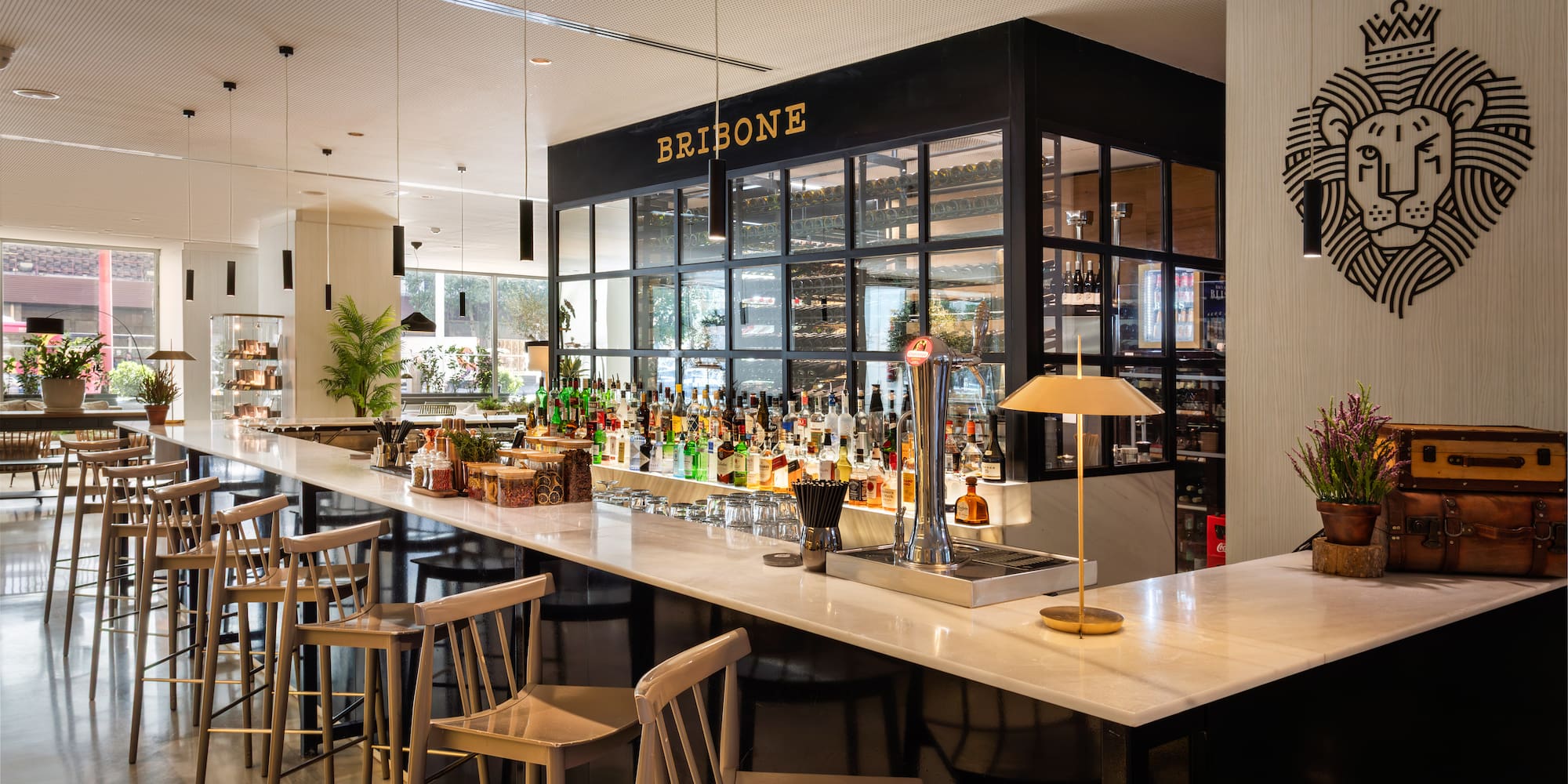 a bar with a variety of bottles and chairs