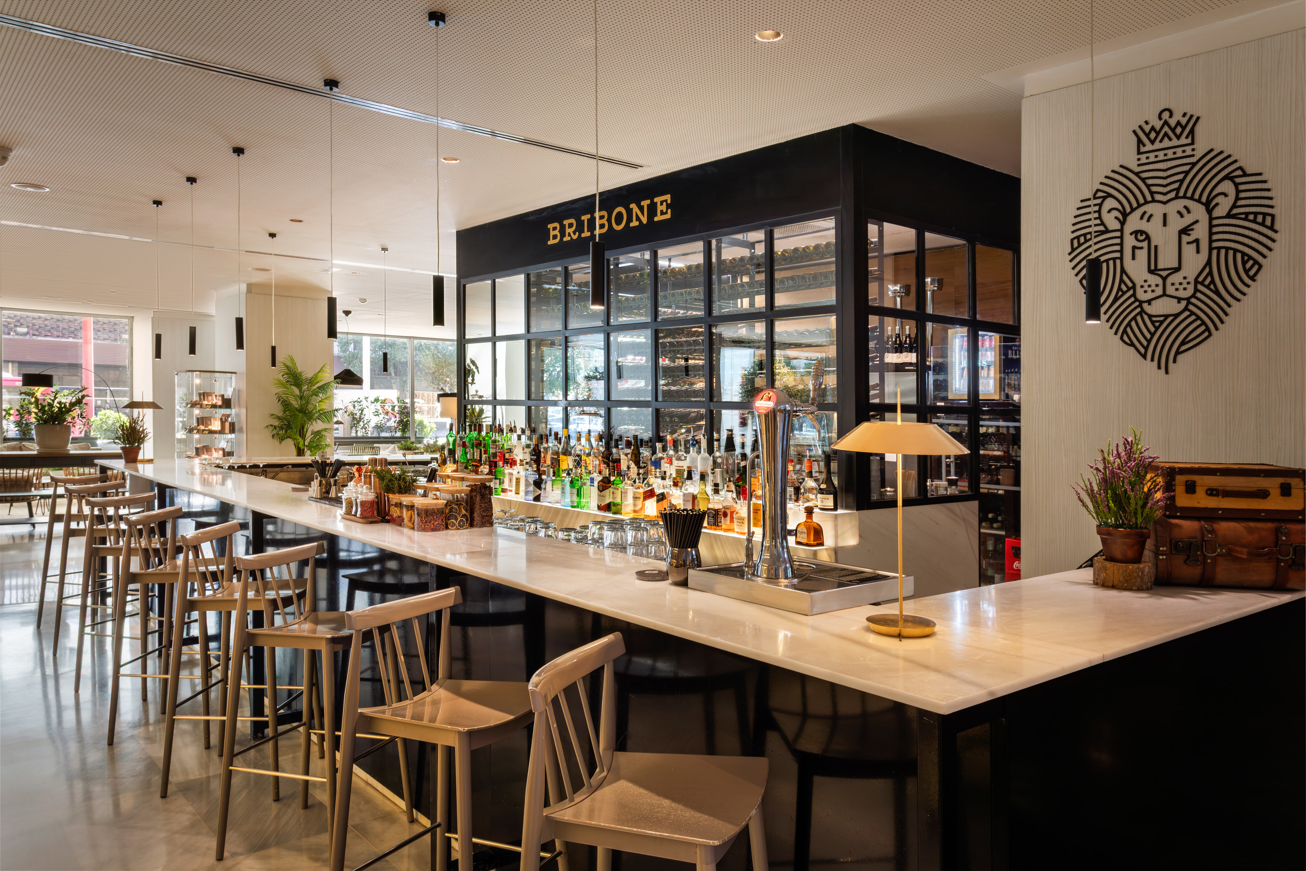 a bar with a variety of bottles and chairs