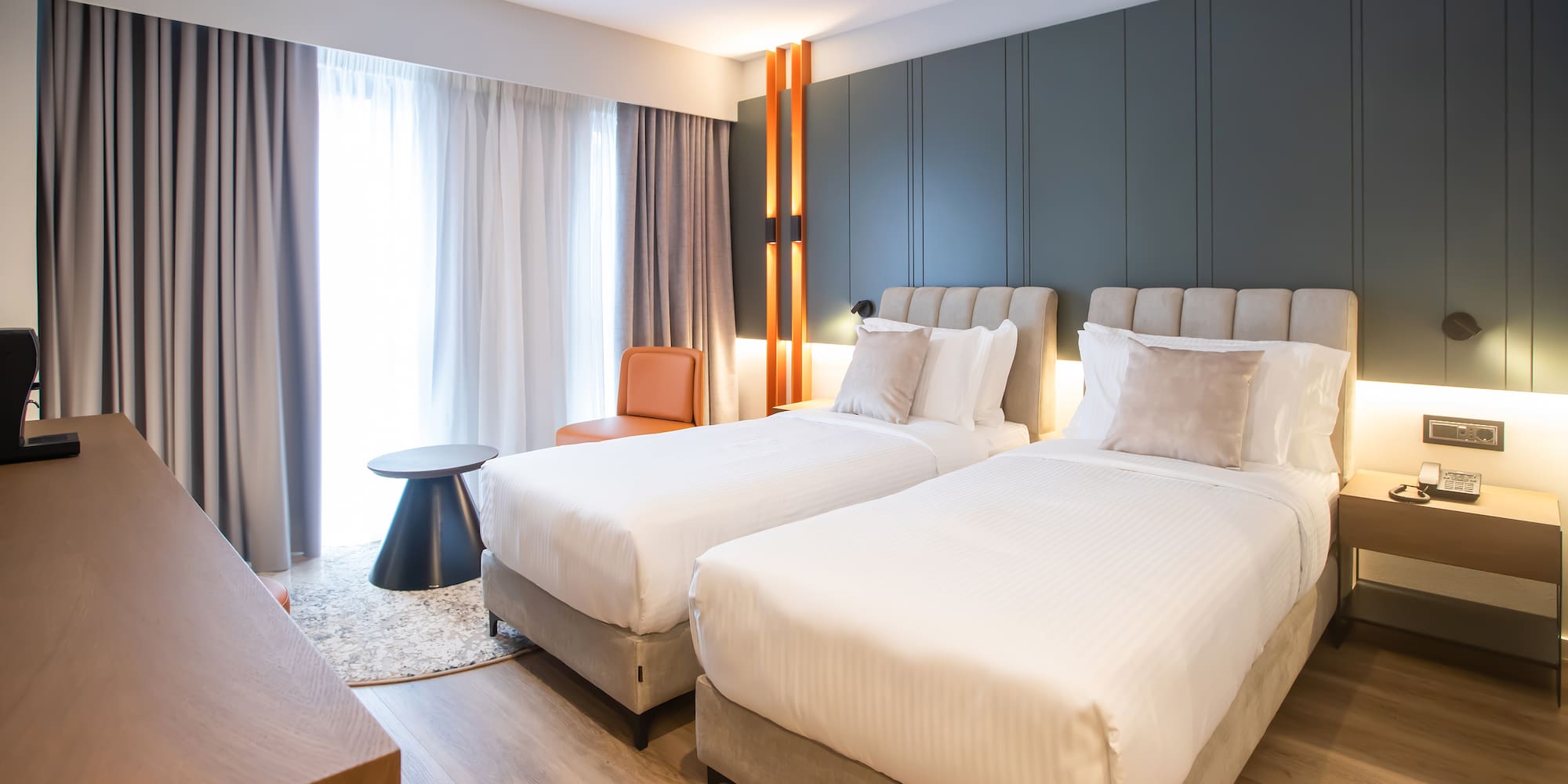 a room with two beds and a table