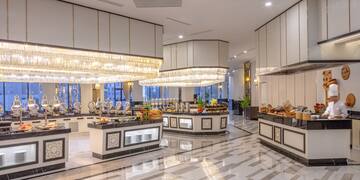 a large room with a buffet and chandeliers