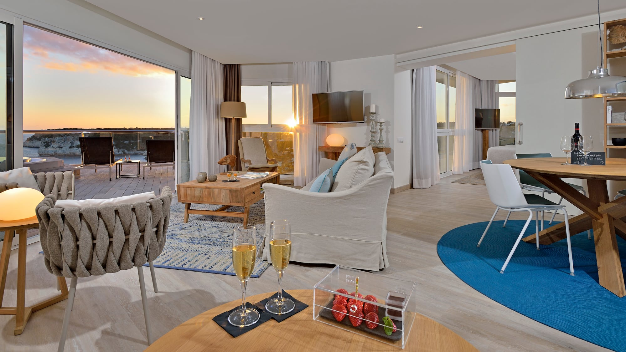 a room with a couch and a table with wine glasses