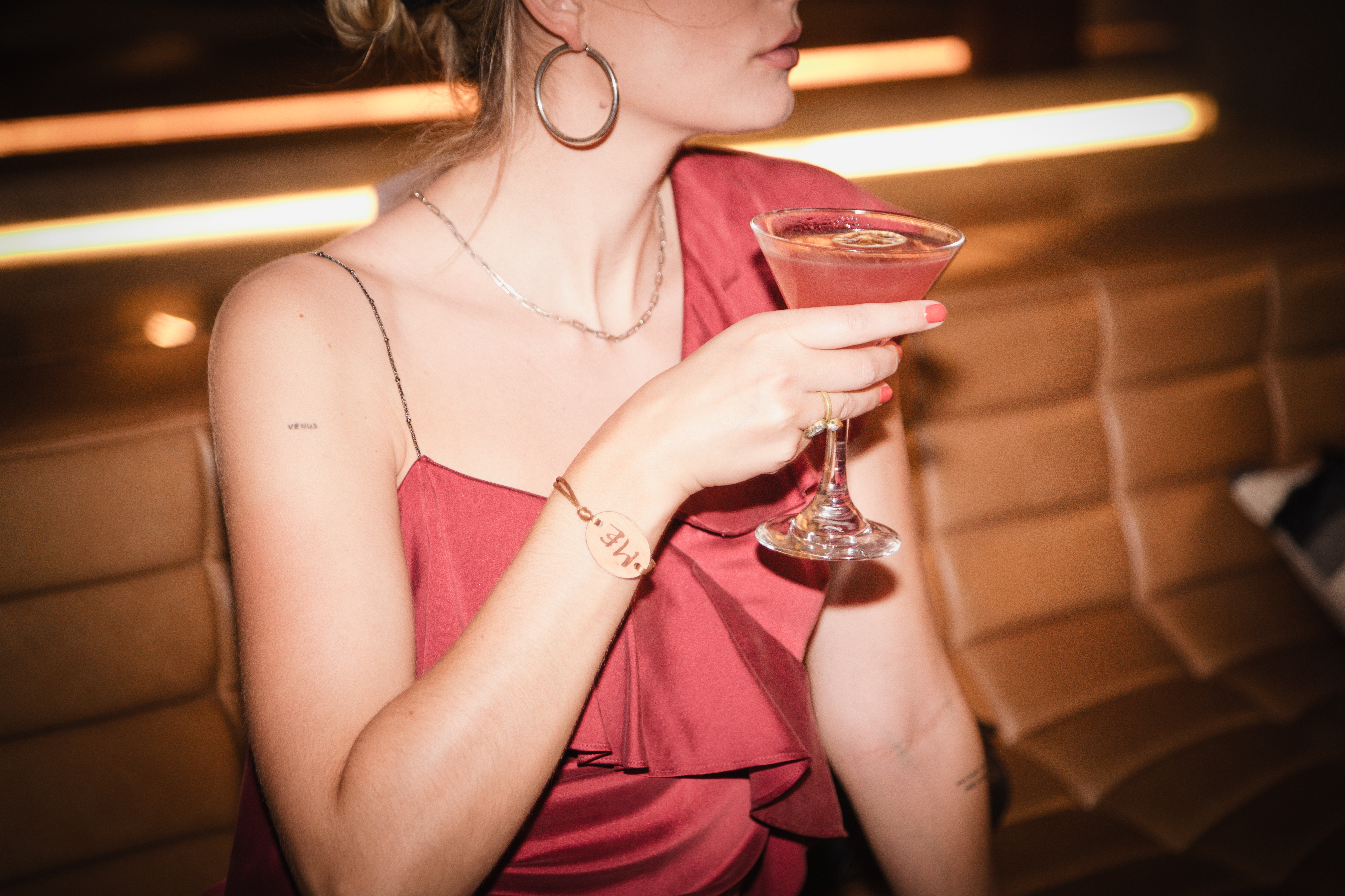 a woman holding a drink