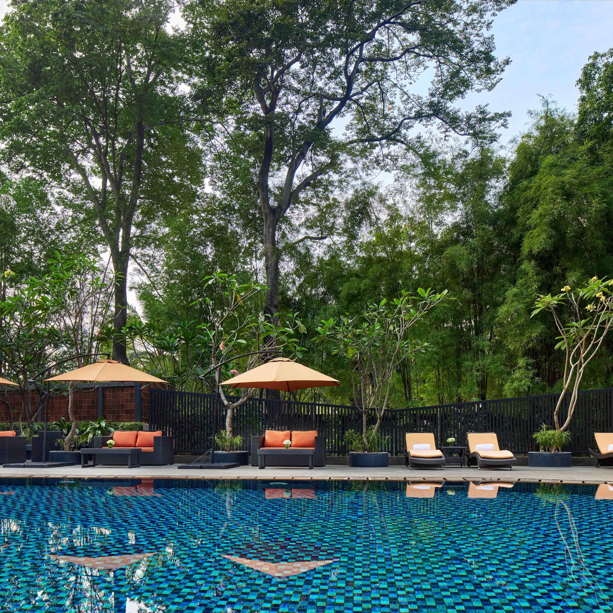 a pool with chairs and umbrellas