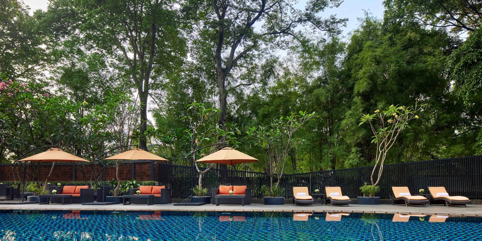 a pool with chairs and umbrellas