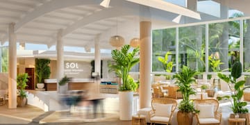 a room with a large white ceiling and plants