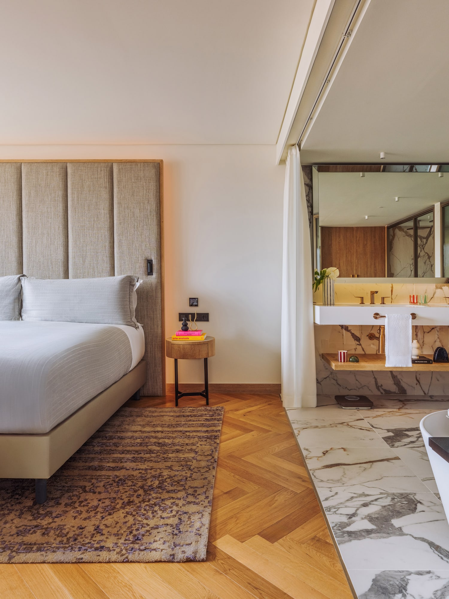 a bedroom with a large bed and a bathtub