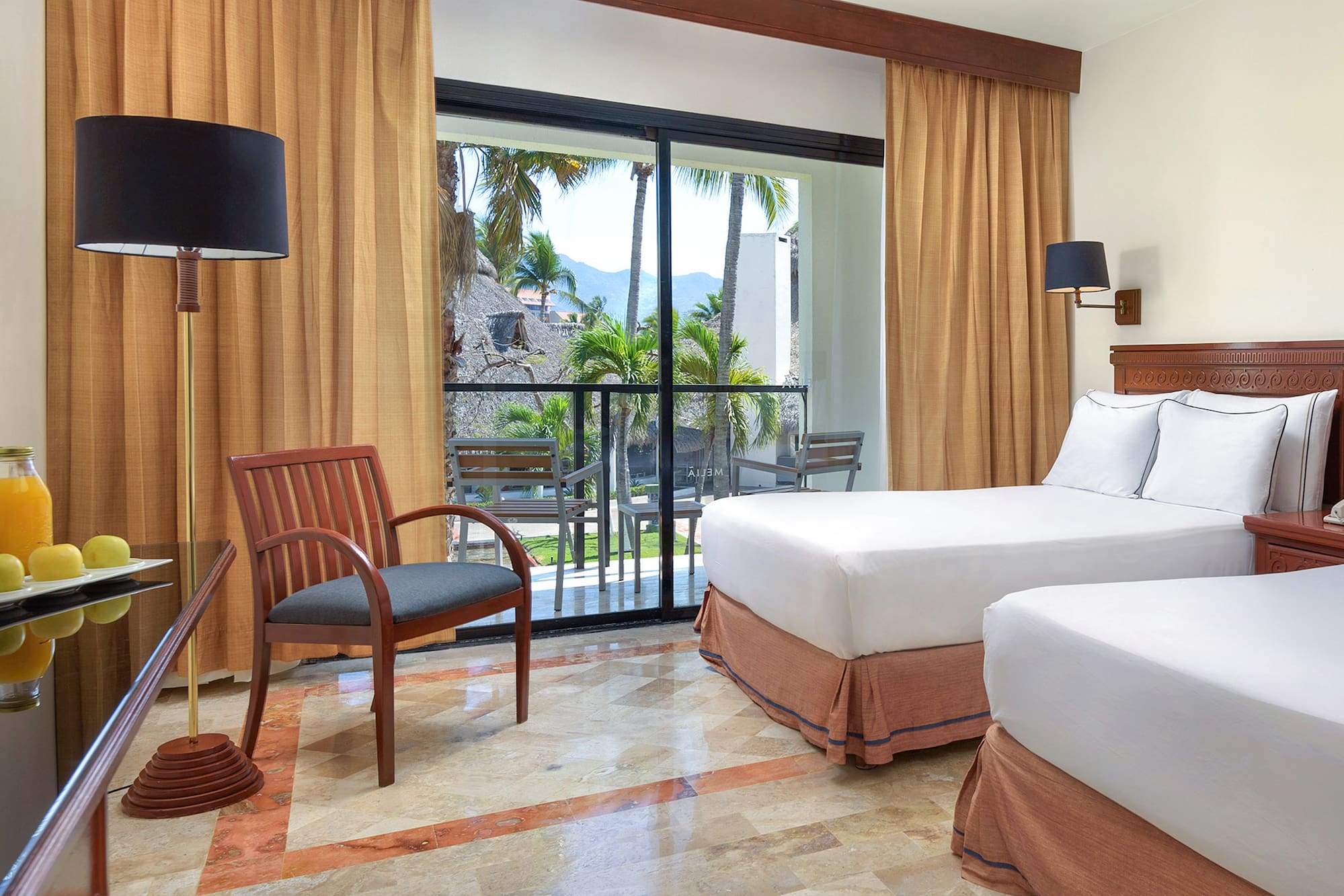 a room with two beds and a chair