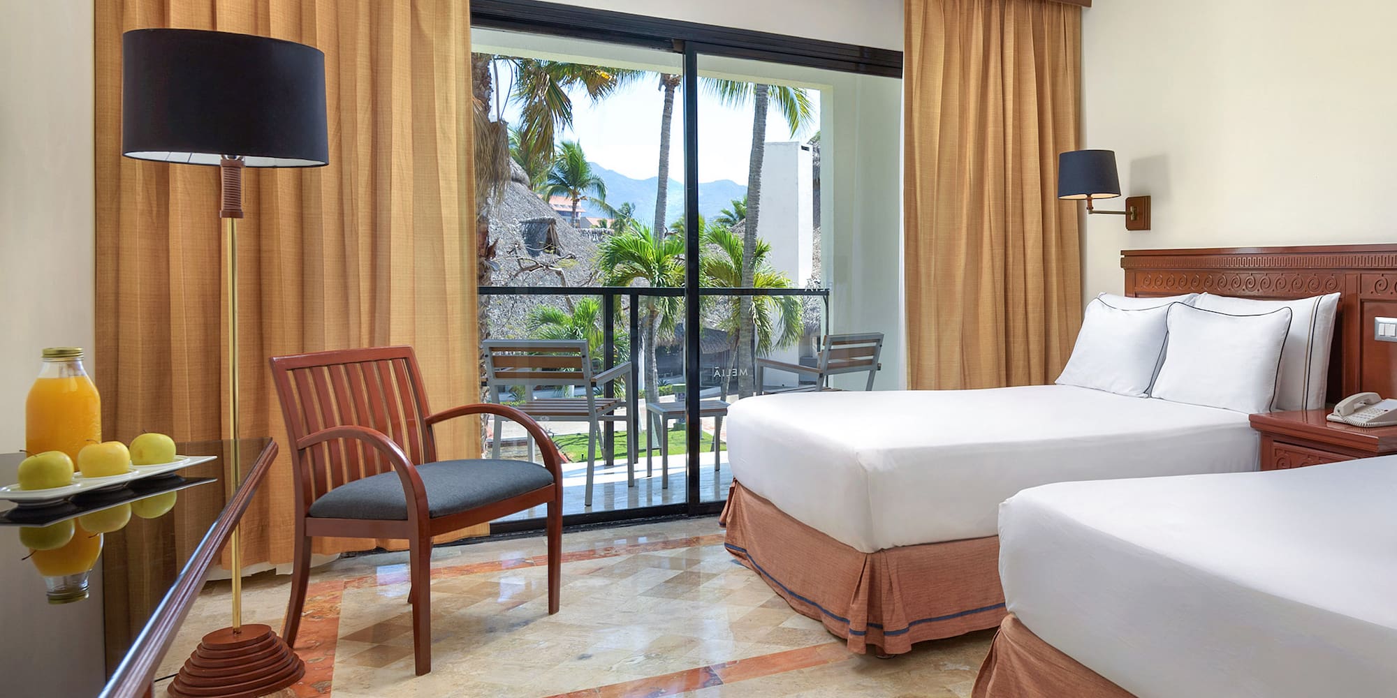 a room with two beds and a chair