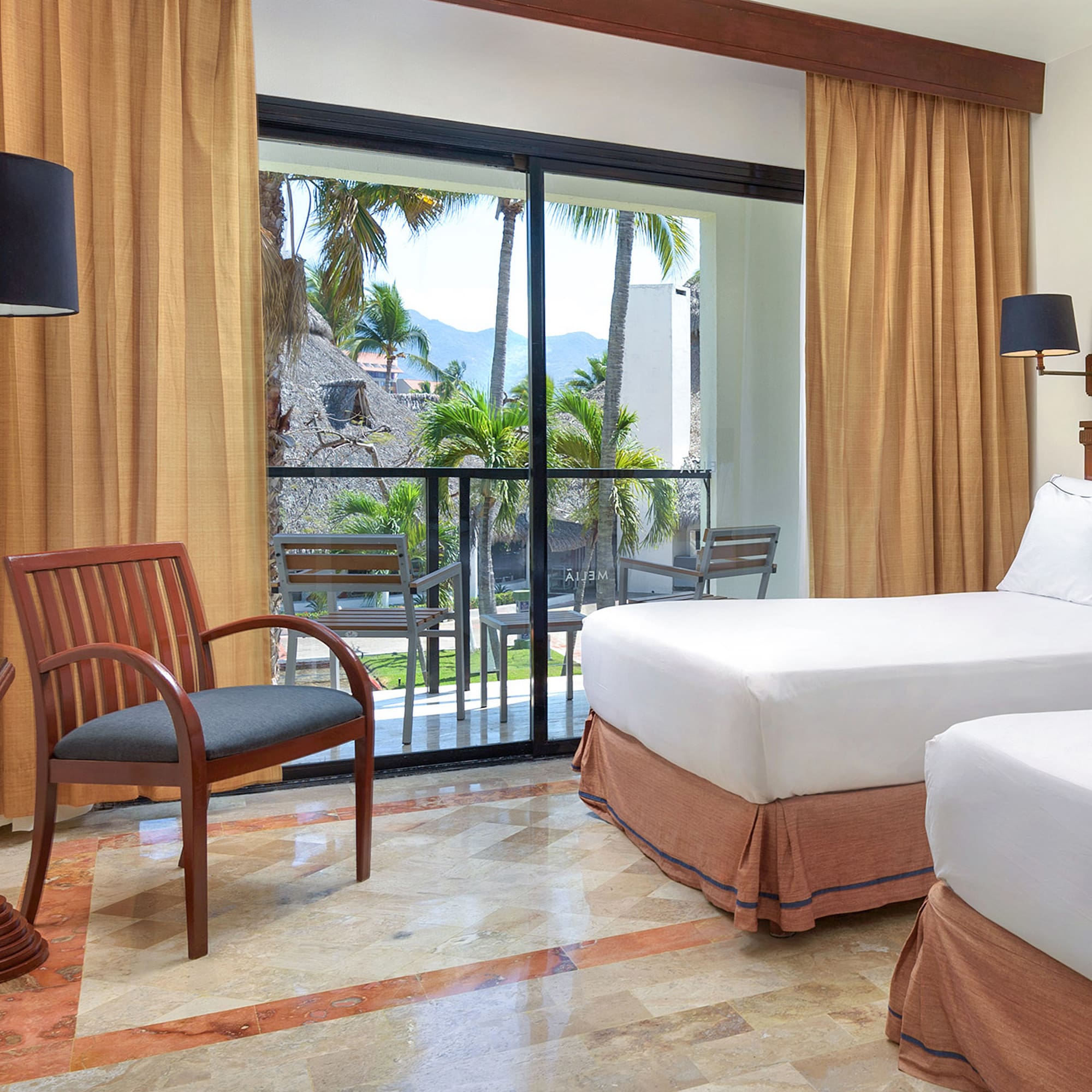 a room with two beds and a chair