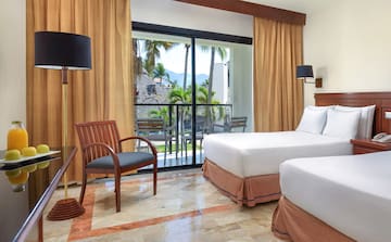 a room with two beds and a chair