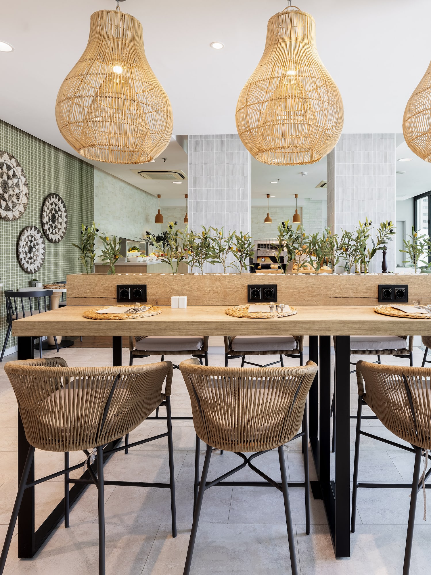 a dining table with chairs and wicker lamps