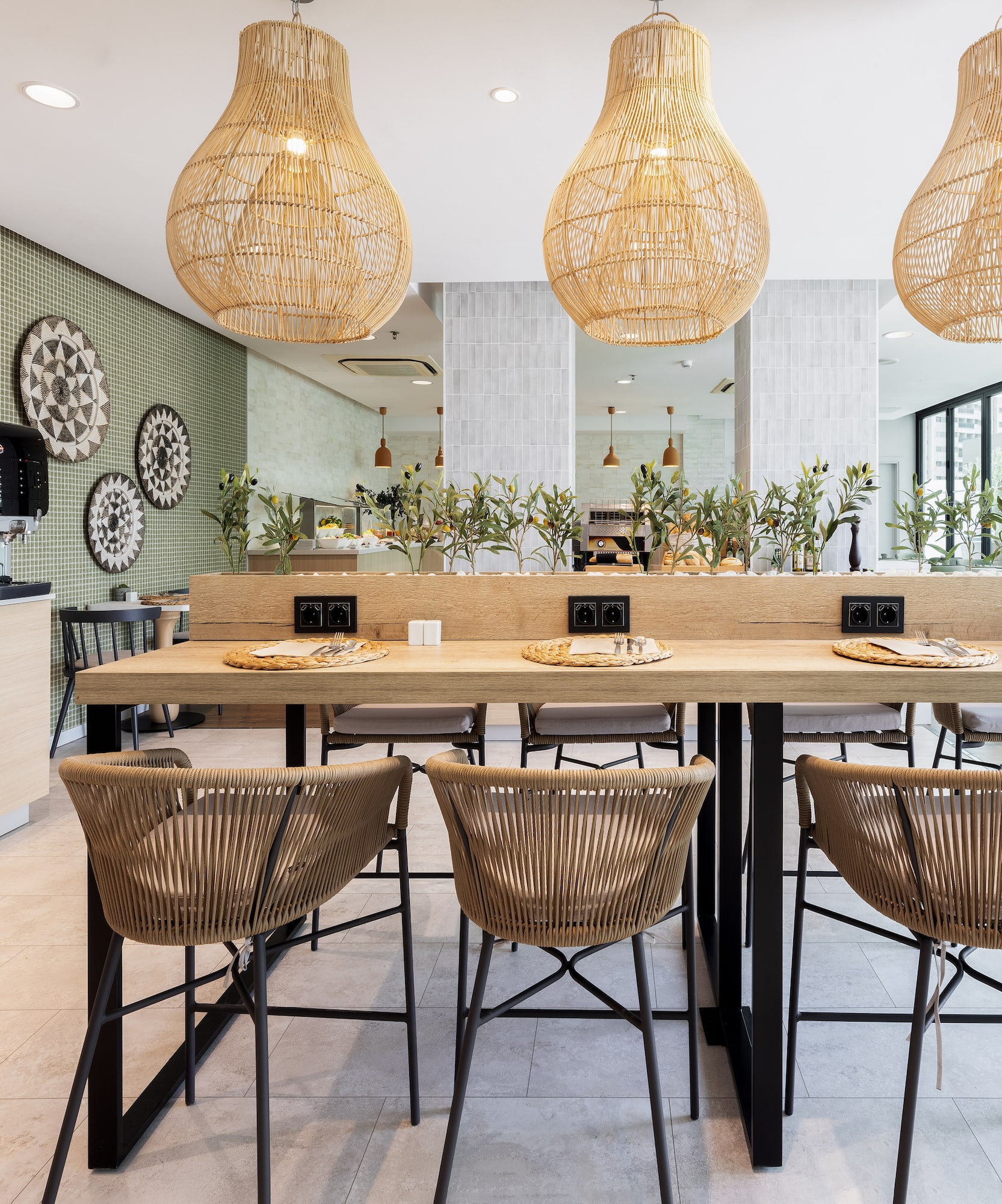 a dining table with chairs and wicker lamps