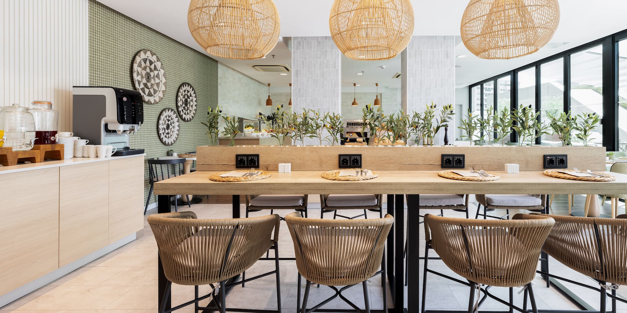 a dining table with chairs and wicker lamps