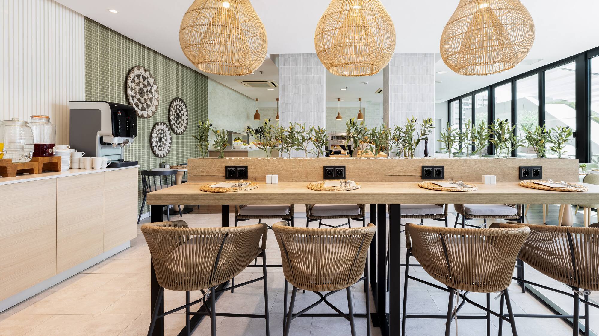 a dining table with chairs and wicker lamps