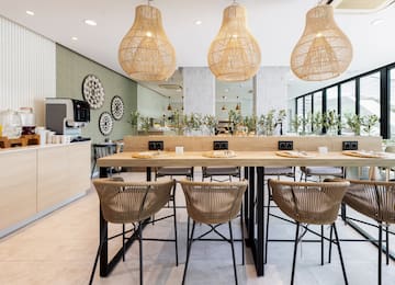 a dining table with chairs and wicker lamps