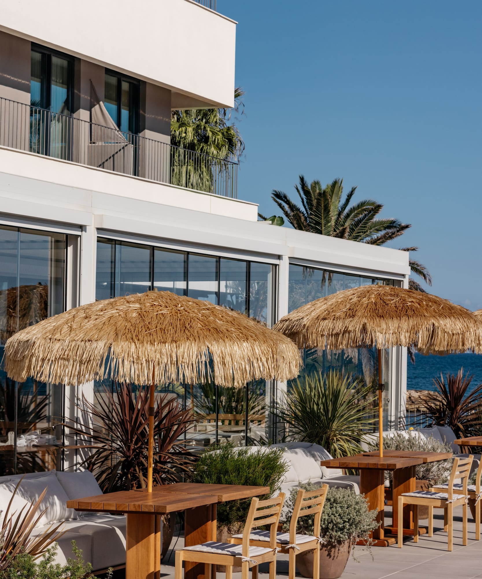 a building with a beach and a beach umbrella