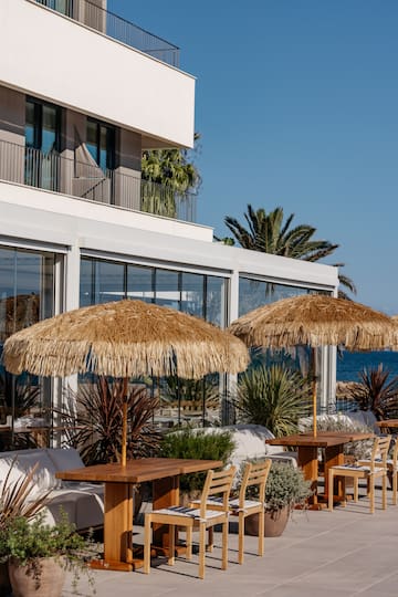 a building with a beach and a beach umbrella