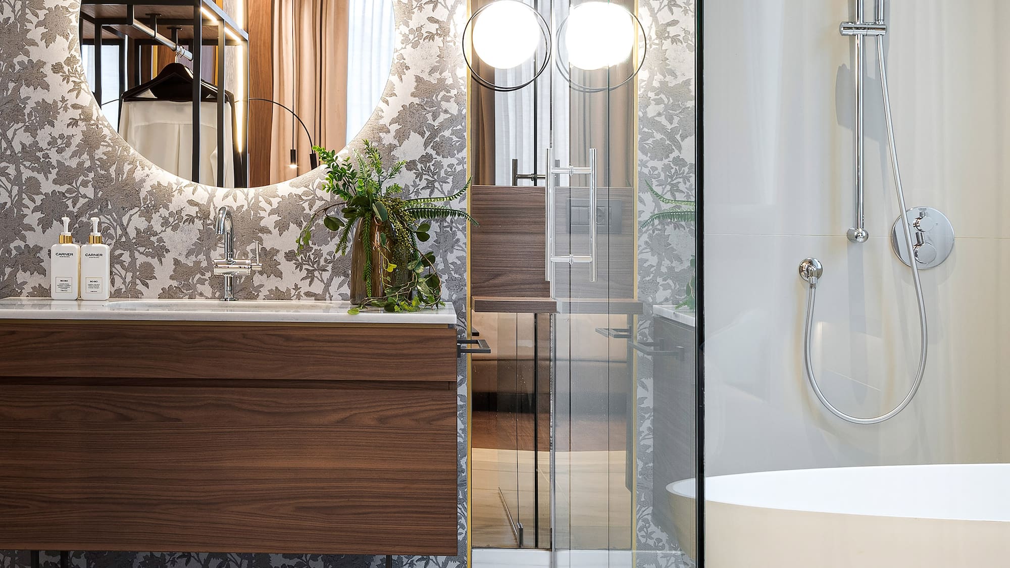 a bathroom with a sink and a round mirror